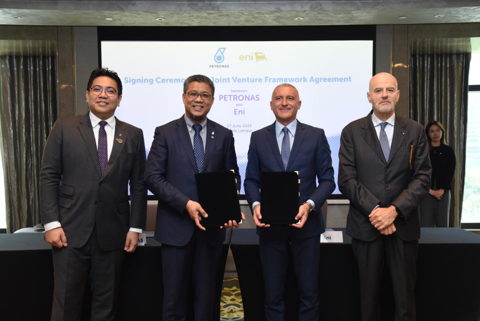 Four men standing side by side at an agreement signing ceremony